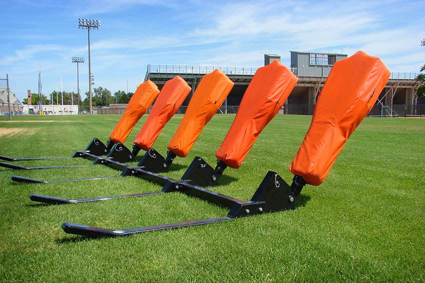 A row of orange blocking shields on the field